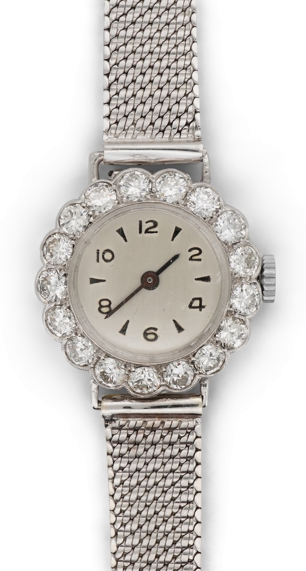 A lady's early 1940's platinum and diamond set manual wind cocktail watch, on a 9ct white gold mesh link bracelet
